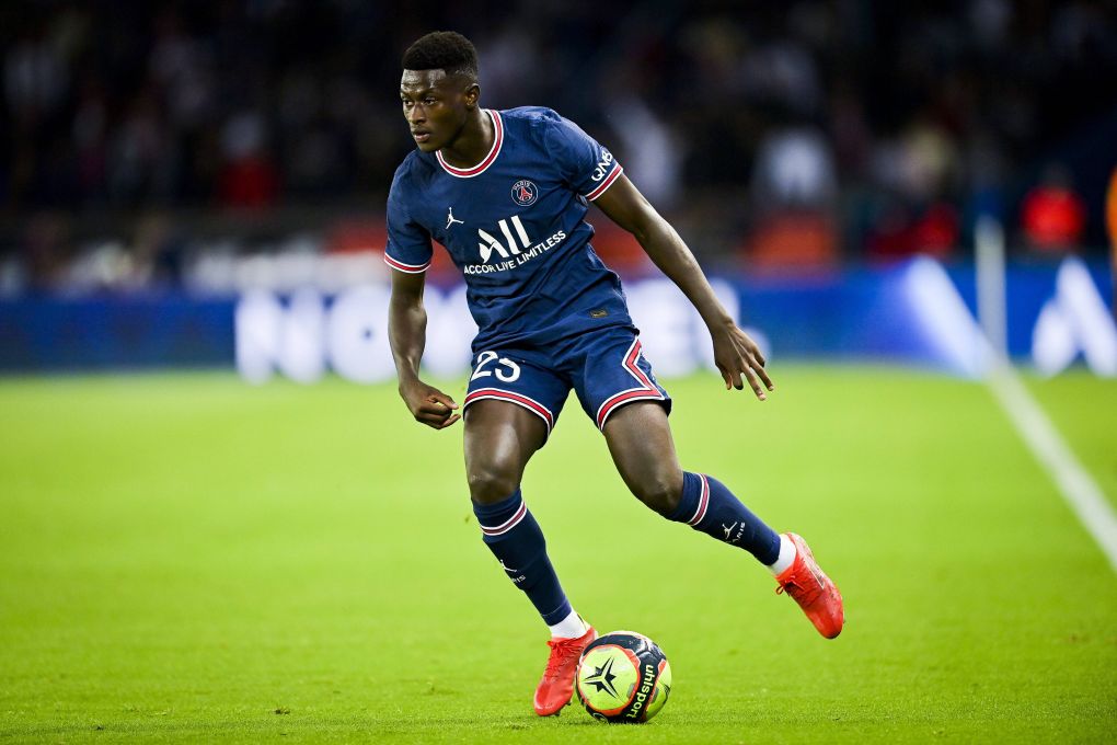  Nuno Mendes, wearing a blue and red Paris Saint-Germain jersey with the number 25, playing leftback during a soccer match.